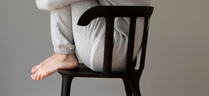 full-shot-woman-sitting-chair (1)