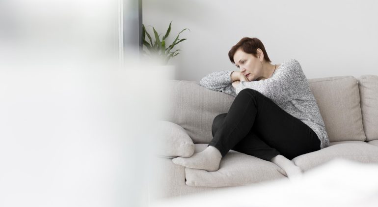 front-view-woman-sitting-couch front-view-woman-sitting-couch